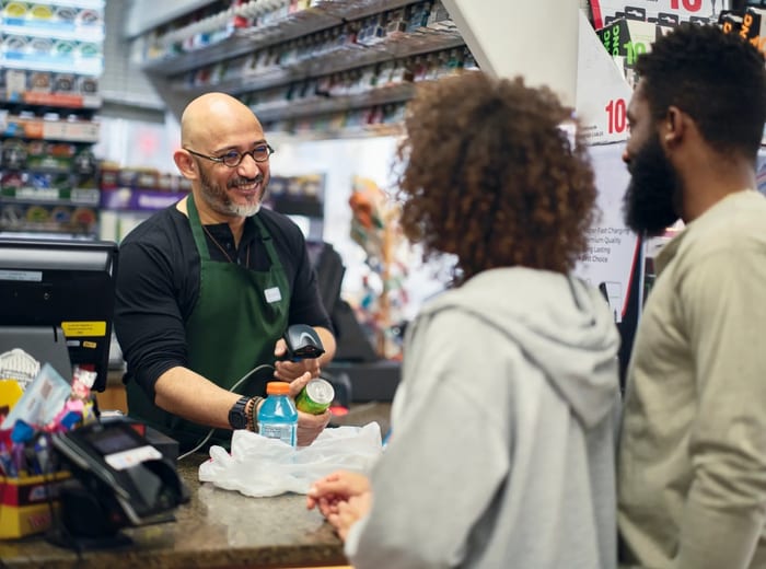 Dispensary staff helping a patient at the counter