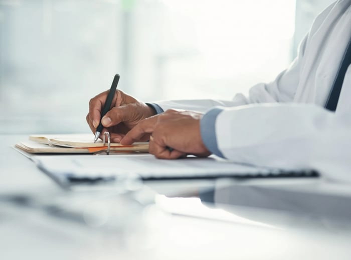 Doctor reviewing legal healthcare compliance documents